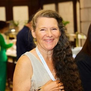 Smiling woman at conference wearing name badge