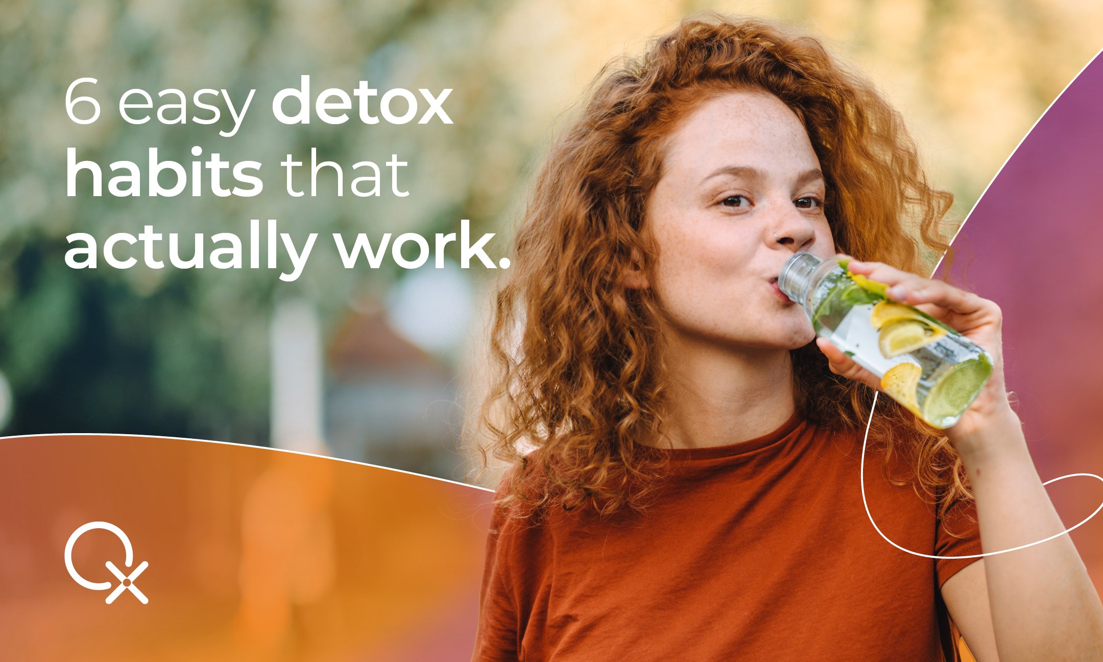 Detox ingredients on a kitchen counter including lemon, leafy greens, beets, ginger, garlic, and broccoli with a glass of lemon water