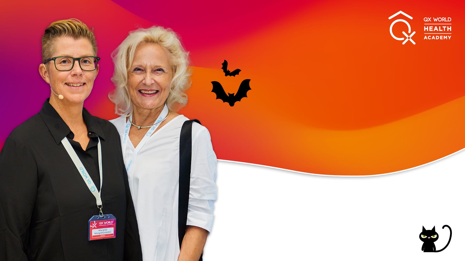 Two women at health academy event with Halloween graphics